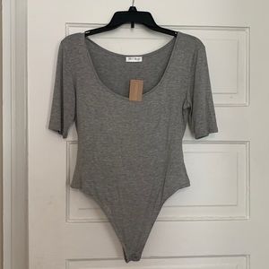 Greg scoopneck body suit. New with tag